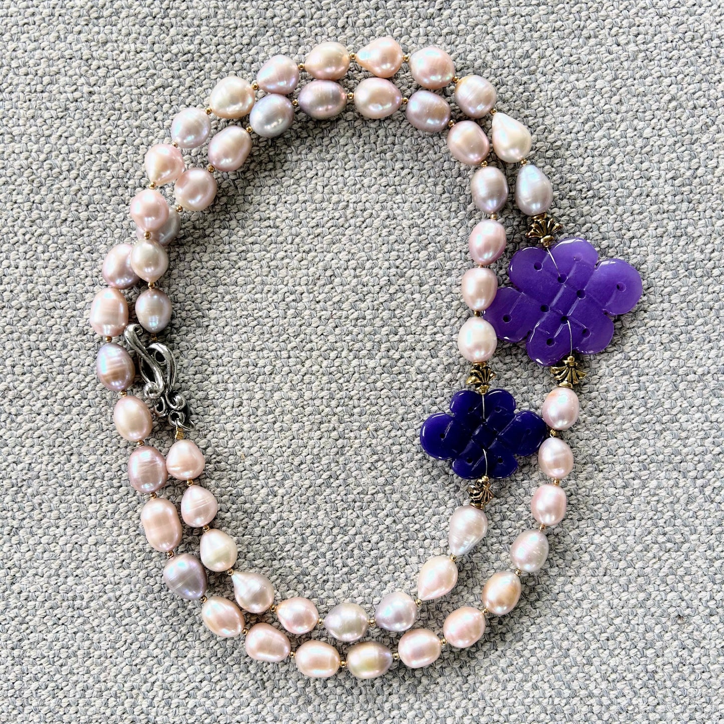 Freshwater pearl necklace with purple jade infinity knot carvings