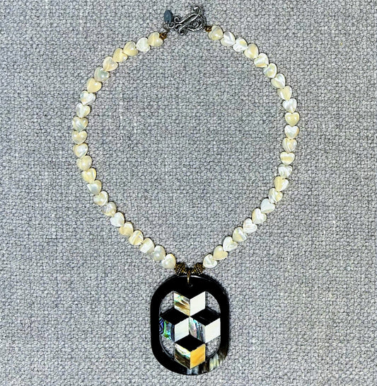 Mother of pearl necklace with a buffalo horn pendant inlaid with abalone shell