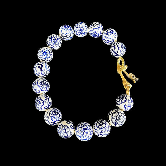 Blue and white ceramic necklace with brass dragon clasp