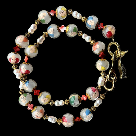 Reverse painted glass bead necklace withpeanut freshwater pearls and conch clovers